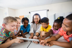 children and teacher in a classroom