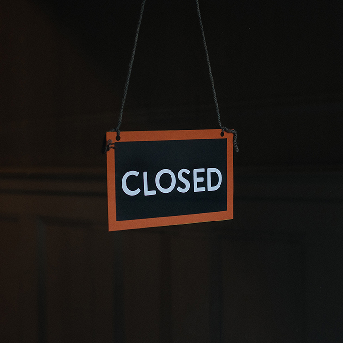 closed sign in darkened window